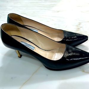 Prada pumps black with brass heel.